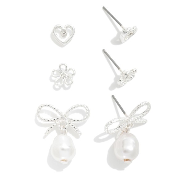 Set Of Three Metal Tone Stud Earrings Featuring Flower, Heart, & Bow

- Approximately .25" L - .75" L
