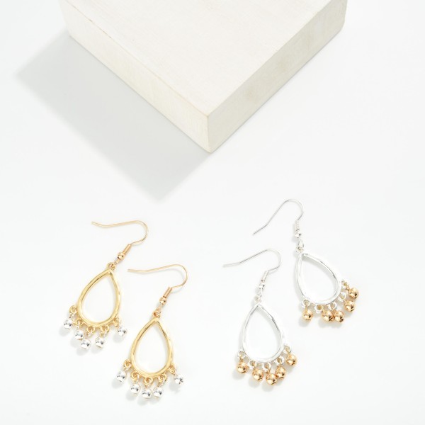 Metal Tone Textured Wire Teardrop Hoop Earring Featuring Metal Ball Bead Dangle Detail 

- Approximately 2" L 