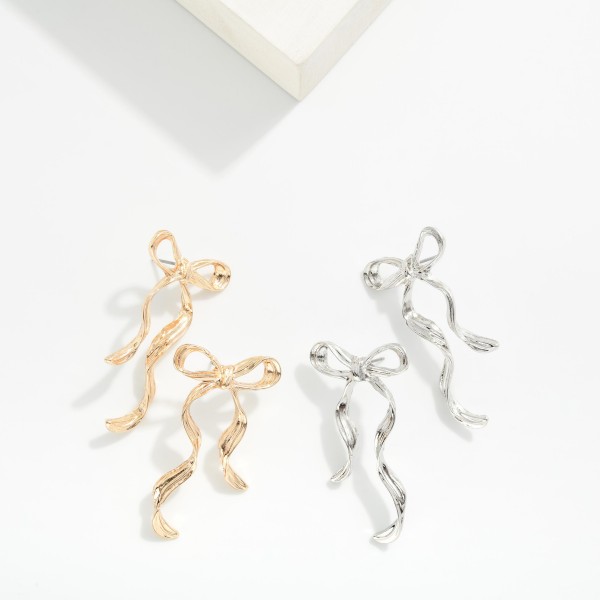 Textured Metal Long Bow Earrings 

- Approximately 2" L