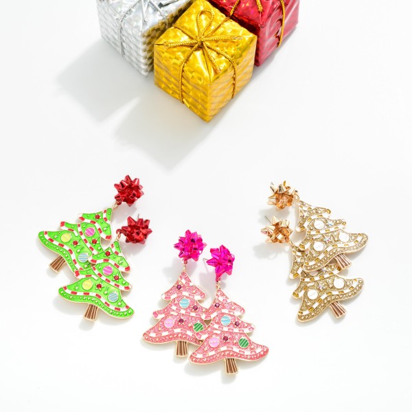 Enamel Christmas Tree Earrings With Metal Bow Post Drop Featuring Glitter, Rhinestone Accents, And Ornament Details 

- Approximately 2.25" L