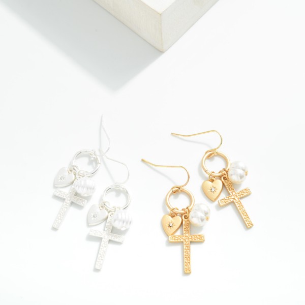 Metal Tone Hoop Drop Earrings Featuring Cross, Pearl, & Heart Charms
- Approximately 1.25" L