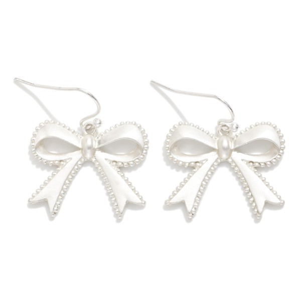 Metal Tone Bow Drop Earrings Featuring Studded Edge Detail 

- Approximately 1" L