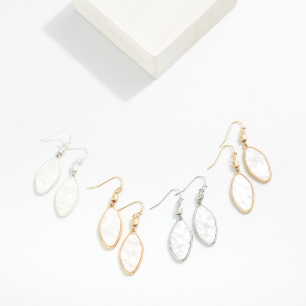 Metal Tone Oval Drop Earrings Featuring Pearl

- Approximately 2" L

