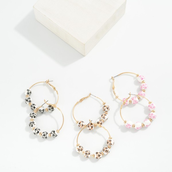 Metal Tone Hoop Drop Earring Featuring Chinoiserie Flower Beads & Gold Tone Disc Bead Stations 

- Approximately 1.5" D 
- Gold Dipped 