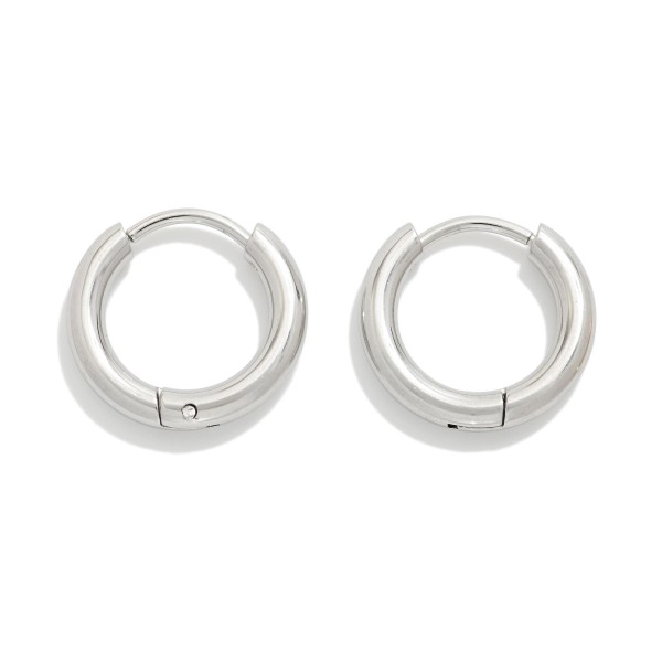 Metal Tone Huggie Hoop Earrings

- Approximately .25" D
- Hypoallergenic 
- Water Resistant 
