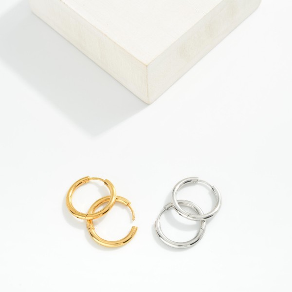 Metal Tone Huggie Hoop Earrings

- Approximately .75" D
- Hypoallergenic 
- Water Resistant 
