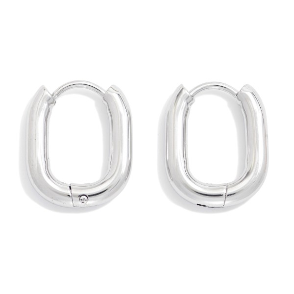 Metal Tone Oval Hinged Huggie Hoop Earrings 

- Stainless Steel
- Water Resistant
- Approximately .25" D
