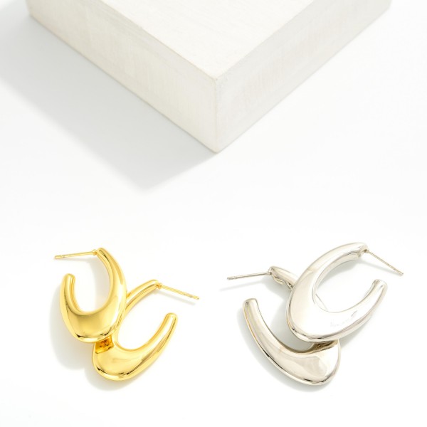 Tapered Metal Tone Oval Hoop Earrings 

- Stainless Steel
- Water Resistant
- Approximately 1.25" L