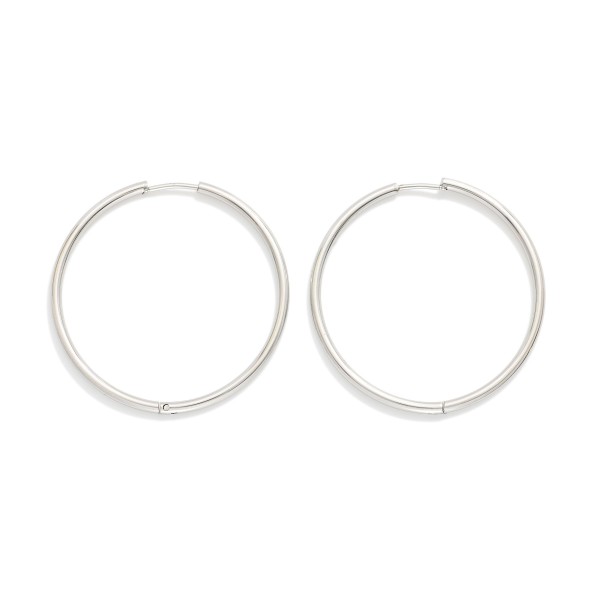 Metal Tone Huggie Hoop Earrings

- Approximately 1.5" D
- Hypoallergenic 
- Water Resistant 
