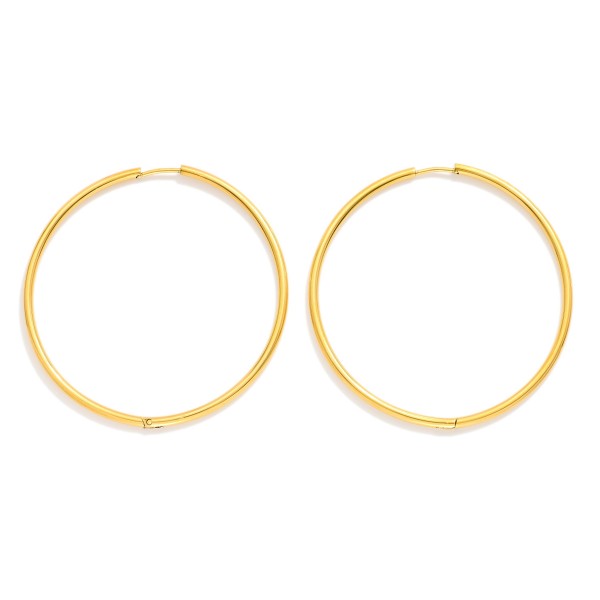 Metal Tone Huggie Hoop Earrings

- Approximately 2" D
- Hypoallergenic 
- Water Resistant 