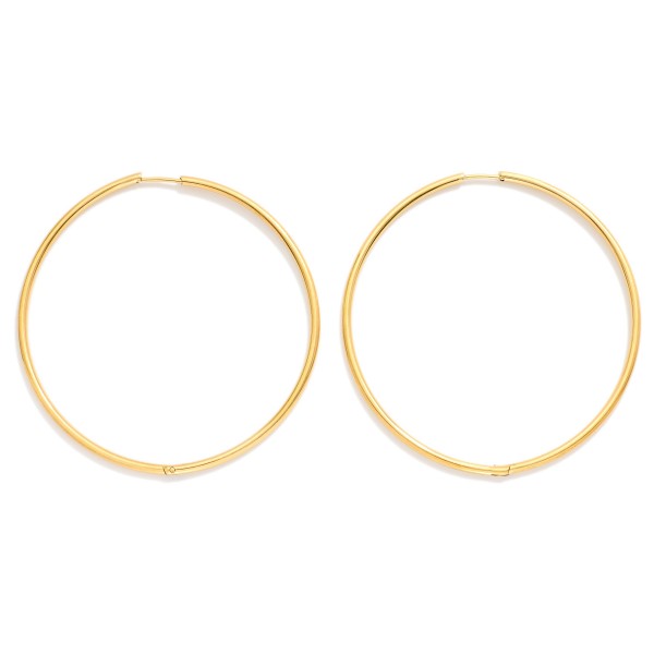 Metal Tone Huggie Hoop Earrings

- Approximately 2.5" D
- Hypoallergenic 
- Water Resistant 
