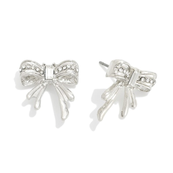 Metal Tone Bow Stud Earrings Featuring Rhinestone Details

- Approximately .75" L