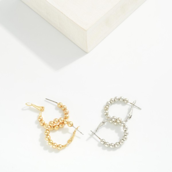 Metal Tone Beaded Hoop Earrings 

- Approximately .5" D