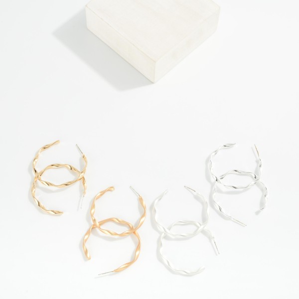 Twisted Metal Hoop Earrings 

- Approximately 1.5" D
