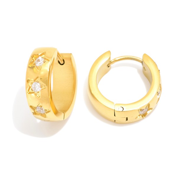 Metal Tone Huggie Hoop Earrings Featuring Rhinestone Star Details 

- Stainless Steel
- Water Resistant
- Approximately .5" D