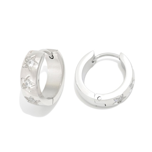 Metal Tone Huggie Hoop Earrings Featuring Rhinestone Star Details 

- Stainless Steel
- Water Resistant
- Approximately .5" D