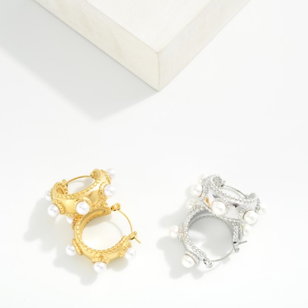 Textured Metal Tone Hoop Earrings Featuring Studded Pearl Details 

- Stainless Steel
- Water Resistant
- Approximately .75" D