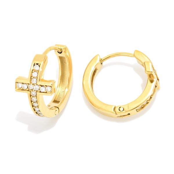 Metal Tone Cross Huggie Hoop Drop Earring Featuring Cubic Zirconia 

- Approximately .5" L 
- Stainless Steel 
- Hypoallergenic 
- Water Resistant 