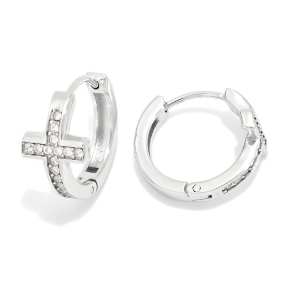 Metal Tone Cross Huggie Hoop Drop Earring Featuring Cubic Zirconia 

- Approximately .5" L 
- Stainless Steel 
- Hypoallergenic 
- Water Resistant 