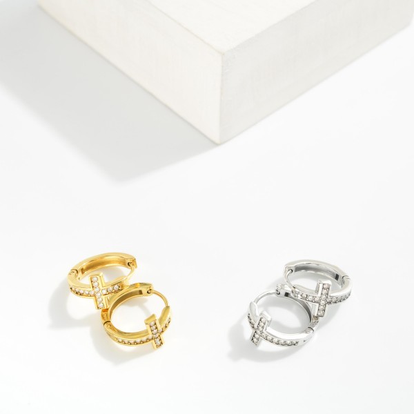 Metal Tone Cross Huggie Hoop Drop Earring Featuring Cubic Zirconia 

- Approximately .5" L 
- Stainless Steel 
- Hypoallergenic 
- Water Resistant 