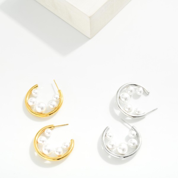 Metal Tone Hoop Earrings Featuring Graduated Pearl Detail 

- Approximately 1" D 