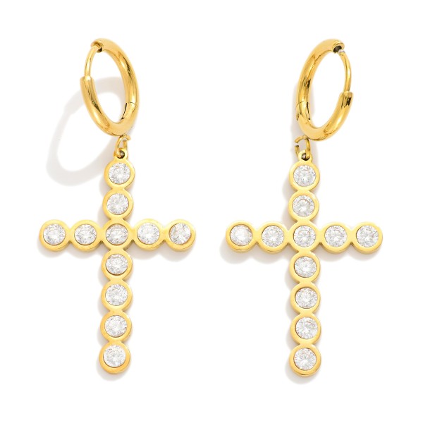 Metal Tone Huggie Hoop Earrings Featuring Rhinestone Studded Cross Dangle 

- Stainless Steel
- Water Resistant
- Approximately 2" L