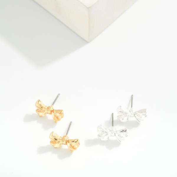 Metal Tone Bow Stud Earrings 

- Approximately .5" L