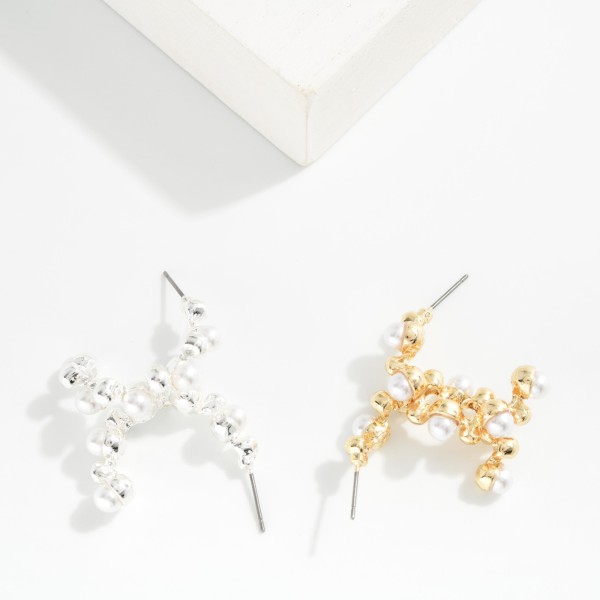 Metal Tone Half Hoop Drop Earring Featuring Pearl & Metal Ball Studded Details 

- Approximately 1" L 