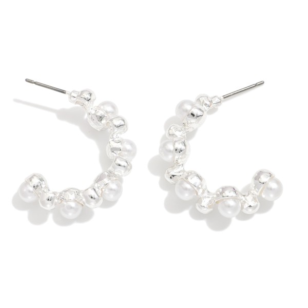 Metal Tone Half Hoop Drop Earring Featuring Pearl & Metal Ball Studded Details 

- Approximately 1" L 