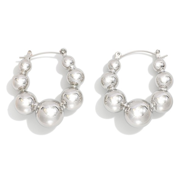 Graduated Metal Tone Beaded Hoop Earrings 

- Approximately 1" L