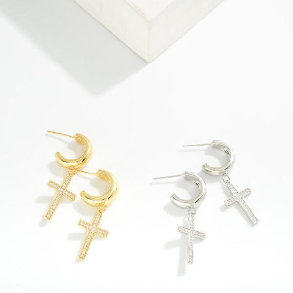 Metal Tone Hoop Earrings Featuring Cubic Zirconia Cross Dangle 

- Gold Dipped
- Approximately 1.25" L