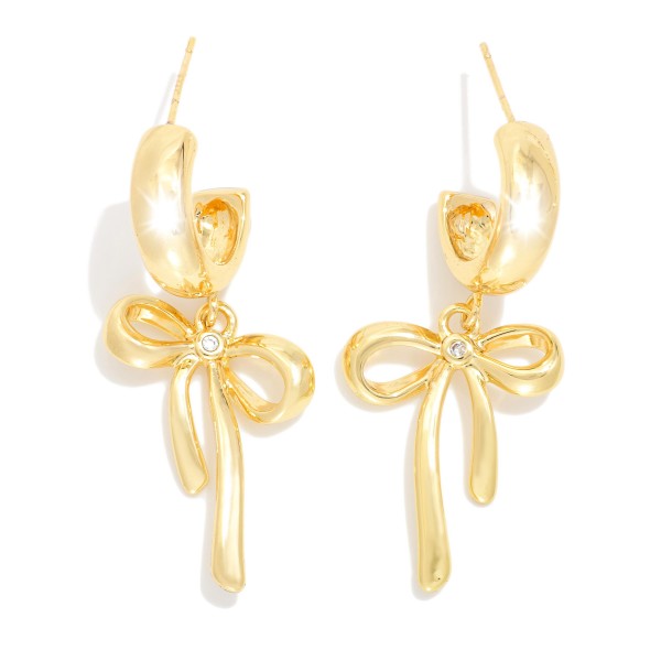  Metal Tone Hoop Earrings Featuring Bow Dangle Detail 

- Gold Dipped 
- Approximately 1.25" L