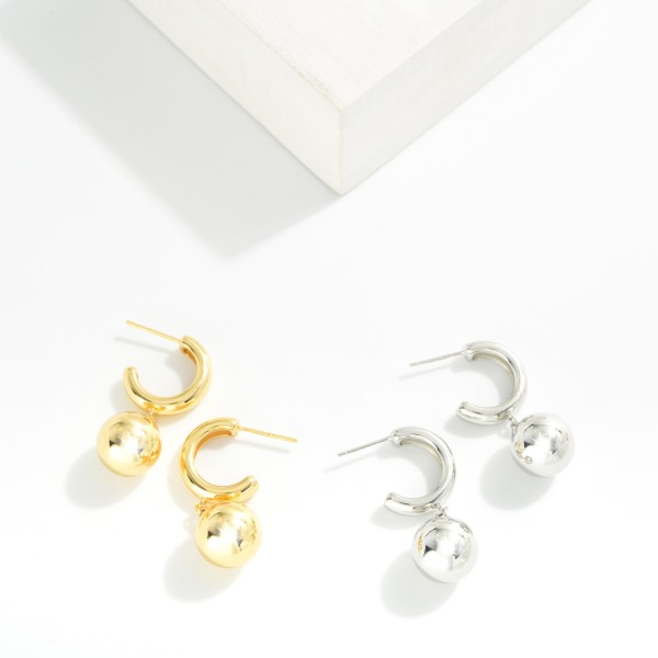 Metal Tone Hoop Earrings Featuring Ball Dangle Detail 

- Gold Dipped 
- Approximately 1" L