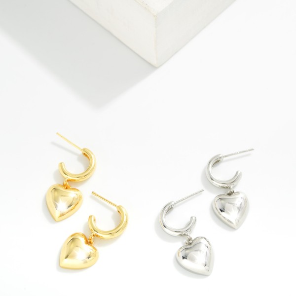 Metal Tone Hoop Earrings Featuring Puffy Heart Dangle Detail 

- Gold Dipped 
- Approximately 1" L