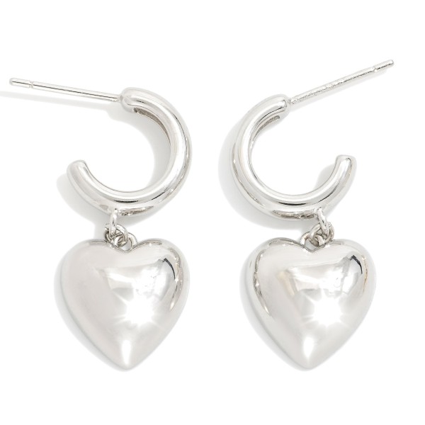 Metal Tone Hoop Earrings Featuring Puffy Heart Dangle Detail 

- Gold Dipped 
- Approximately 1" L