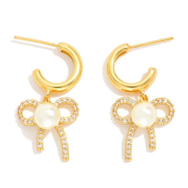  Metal Tone Hoop Earrings Featuring Cubic Zirconia & Pearl Bow Dangle Detail 

- Gold Dipped 
- Approximately 1" L
