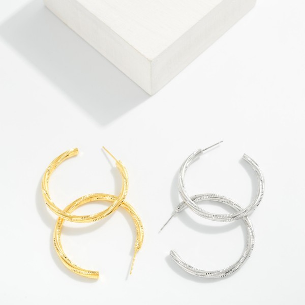 Metal Tone Zig Zag Huggie Hoop Drop Earrings Featuring Cubic Zirconia 

- Approximately 1." D 
- Gold Dipped
- Brass Base 
- Hypoallergenic