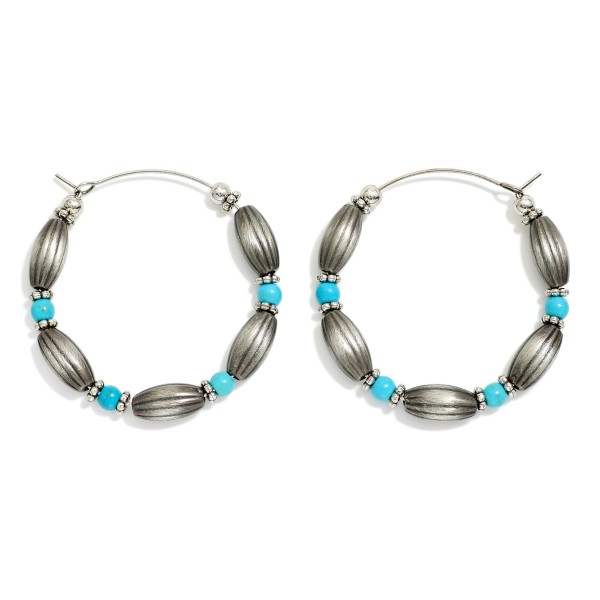 Oval Brushed Metal Beaded Hoop Drop Earring Featuring Stone Beads & Metal Tones 

- Approximately 1.5" D 