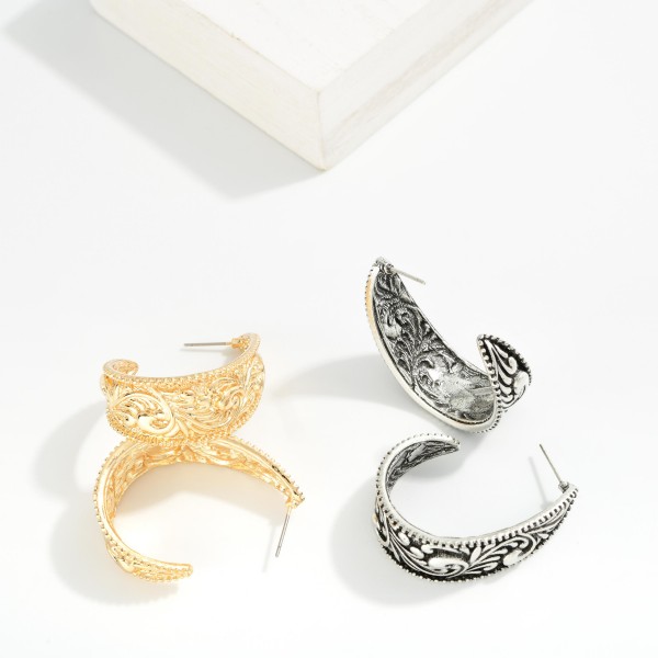 Metal Tone Teardrop Hoop Earring Featuring Engraved Rococo Detail 

- Approximately 1.50" L  