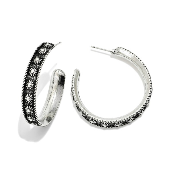 Metal Tone Hoop Drop Earrings Featuring Engraved Flower Detail

- Approximately 1.25" D 