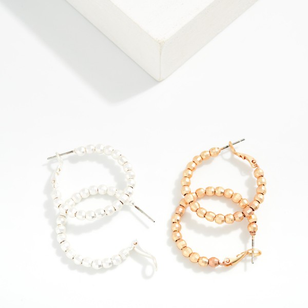 Metal Tone Beaded Huggie Hoop Drop Earring 

- Approximately 1.05" D 