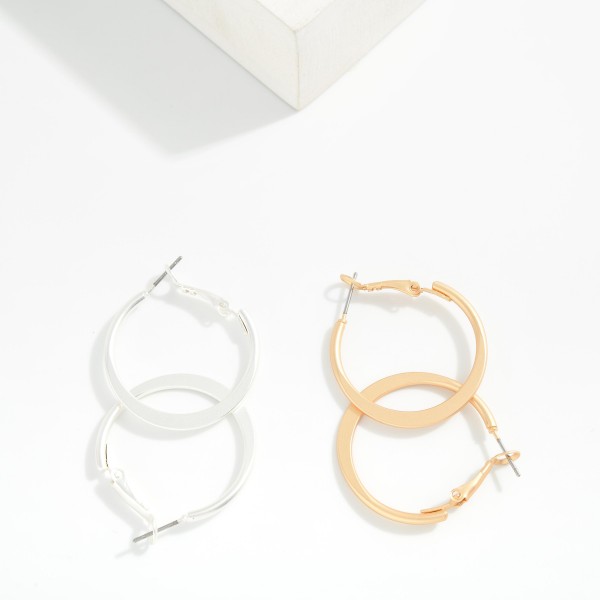 Metal Tone Tapered Flat Hoop Earrings 

- Approximately 1" D