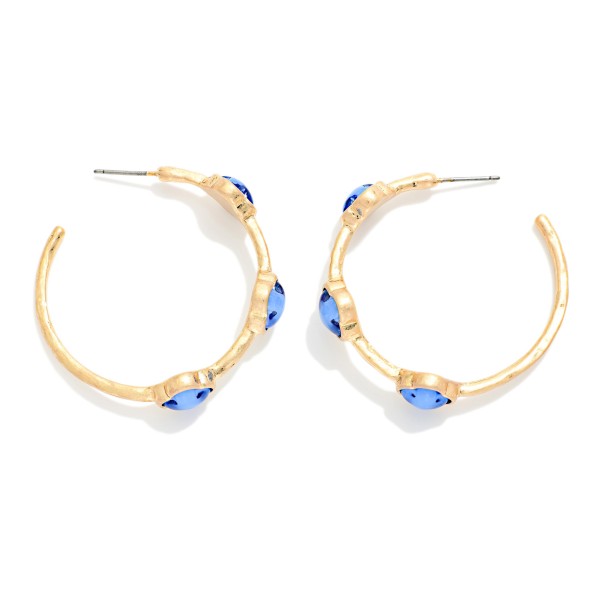 Metal Tone Hoop Earrings Featuring Glitter Acetate Clover Stations 

- Approximately 1.5" L 