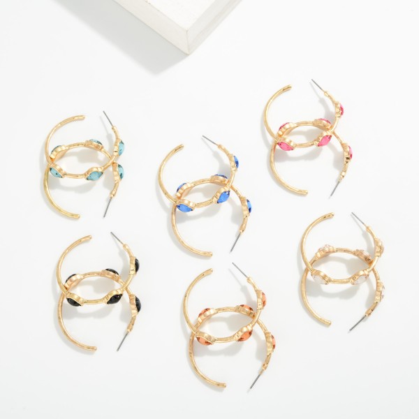 Metal Tone Hoop Earrings Featuring Glitter Acetate Clover Stations 

- Approximately 1.5" L 