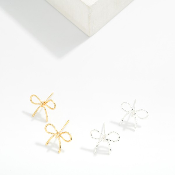 Textured Metal Bow Stud Earrings 

- Brass Base 
- Approximately .75" L