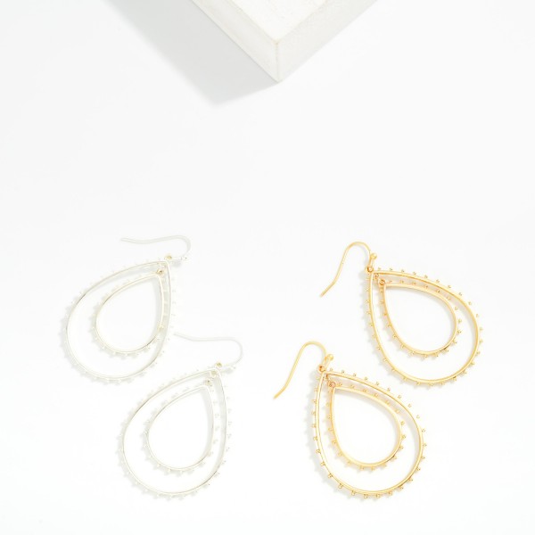 Metal Tone Nesting Teardrop With Studded Metal Ball Detail

- Approximately 2" L 