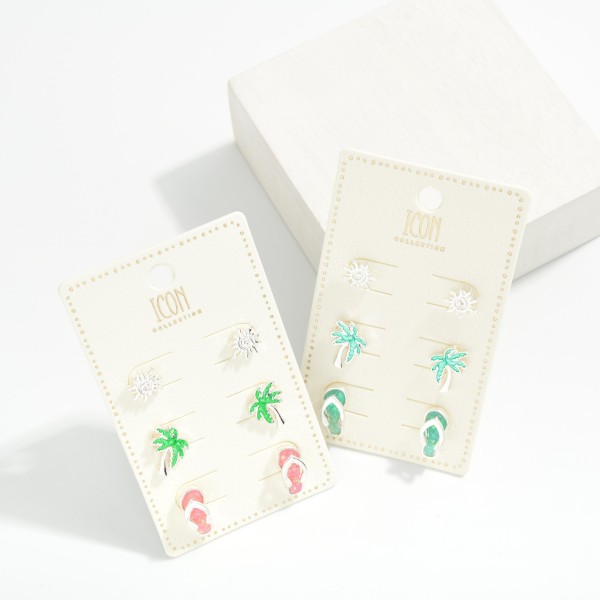 Set Of Three Metal Tone & Glitter Acetate Beach Stud Earrings Featuring Sandal, Palm Tree, And Sun 

- Approximately .5" L