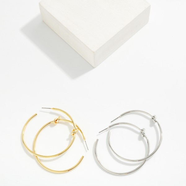 Metal Tone Knotted Hoop Earrings 

- Brass Plated 
- Approximately 2" D