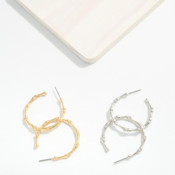 Metal Tone Bamboo Hoop Earrings 

- Approximately 1.25" D