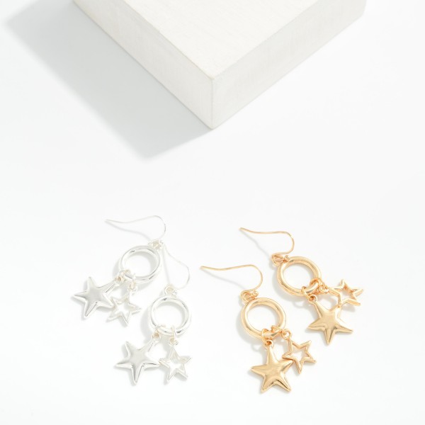Metal Tone Drop Hoop Earrings Featuring Star Charms 

- Approximately 1.75" L
